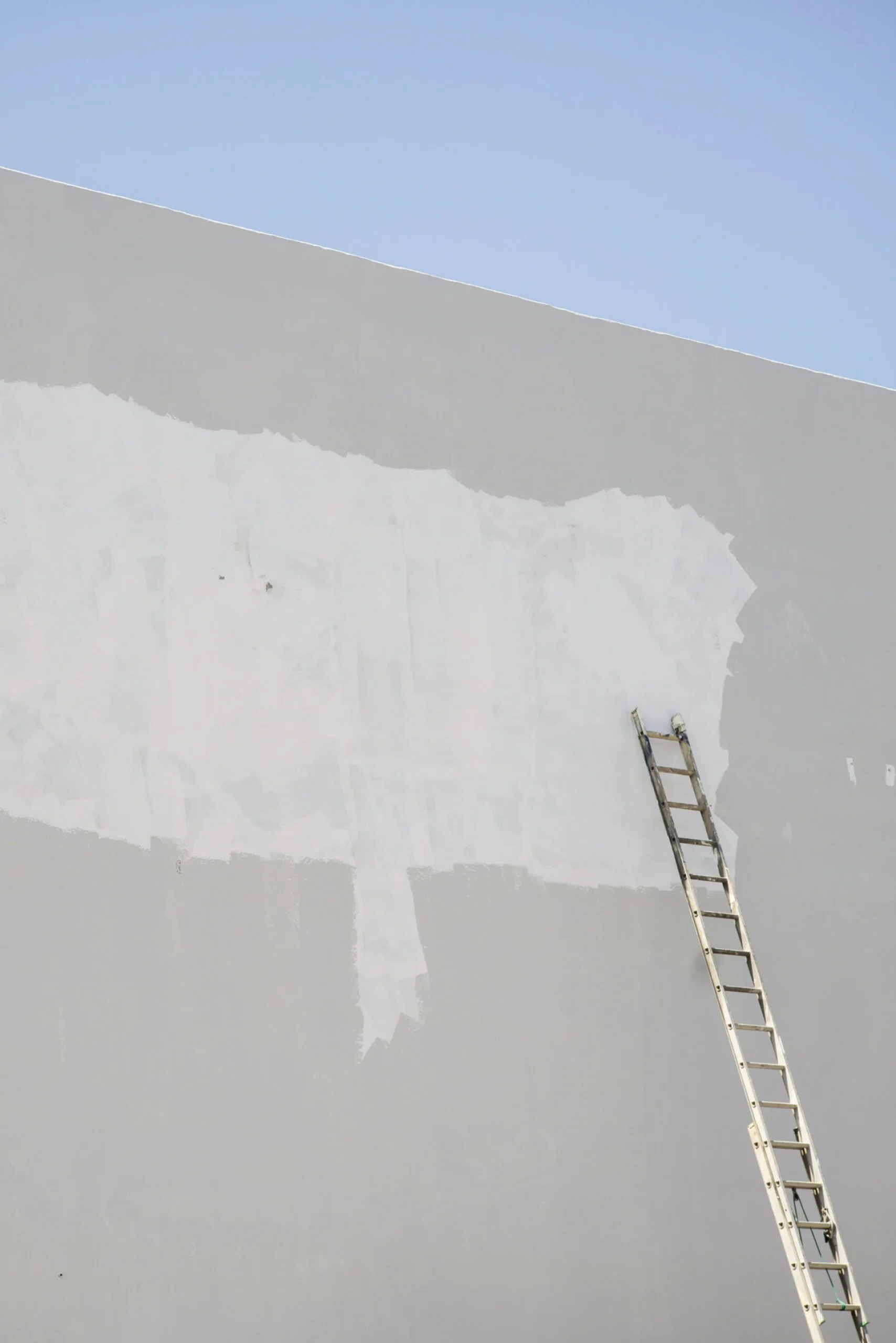 Commercial building undergoing surface preparation for exterior painting in Tampa